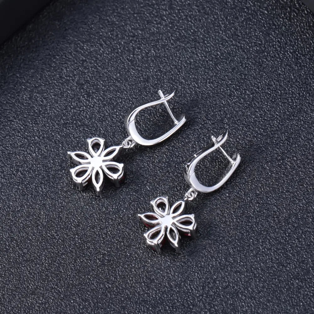 Silver floral drop earrings featuring five deep garnet-brown marquise stones arranged as petals, from the Rossa Collection.