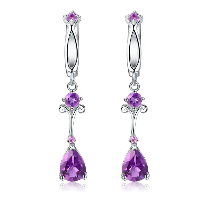 Dangling silver earrings with purple teardrop stones and delicate swirl detailing