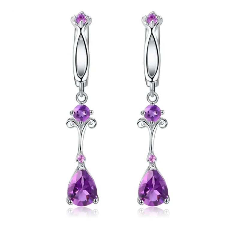Dangling silver earrings with purple teardrop stones and delicate swirl detailing
