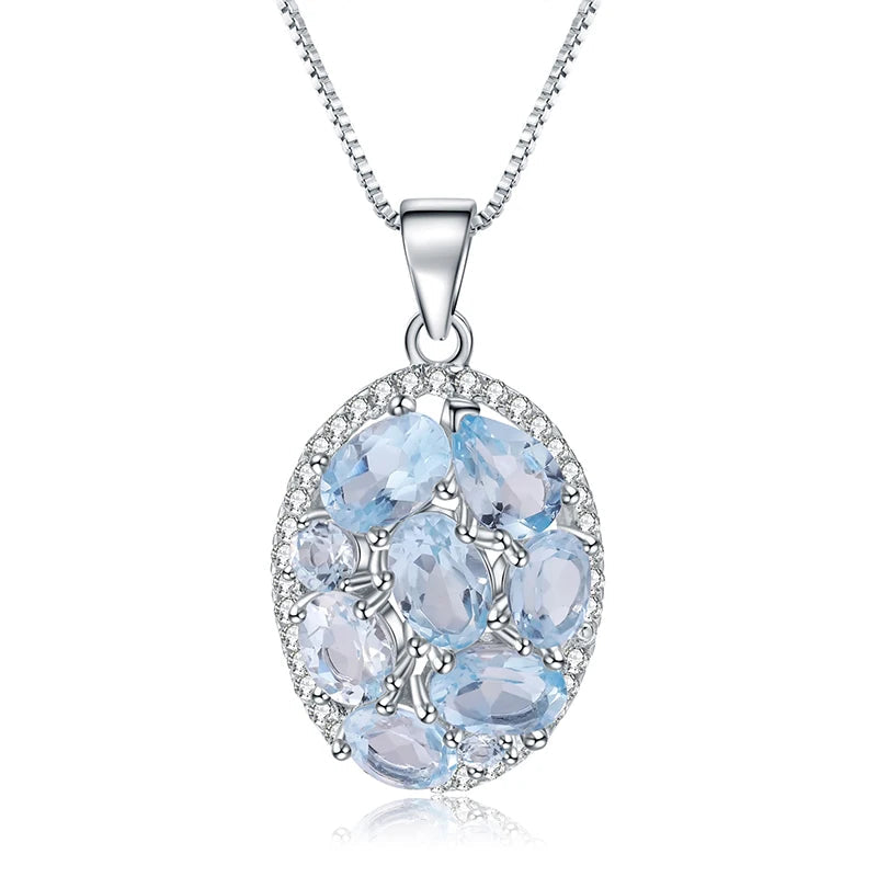 Oval silver pendant with light blue gemstones and surrounding crystal accents