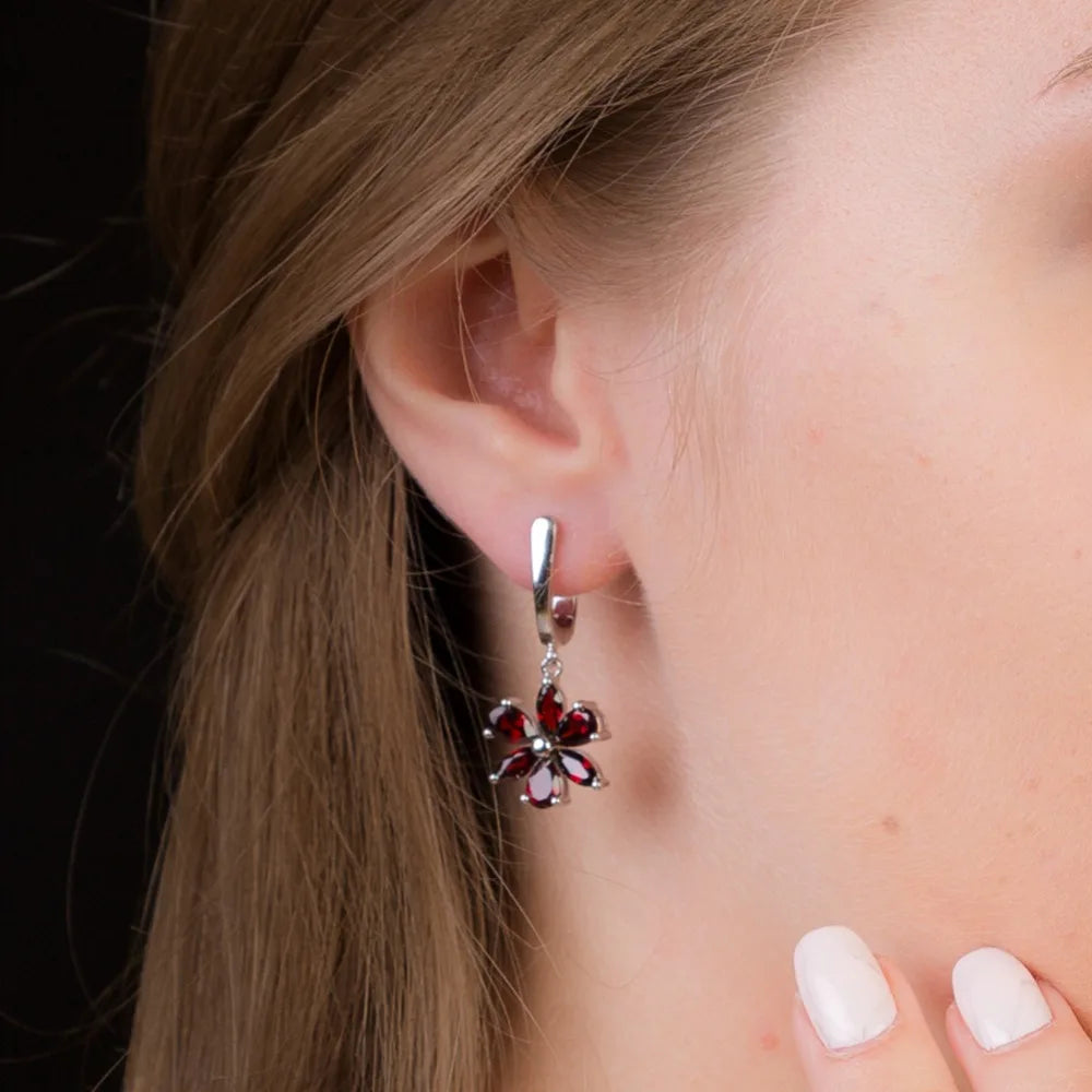 Silver floral drop earrings featuring five deep garnet-brown marquise stones arranged as petals, from the Rossa Collection.