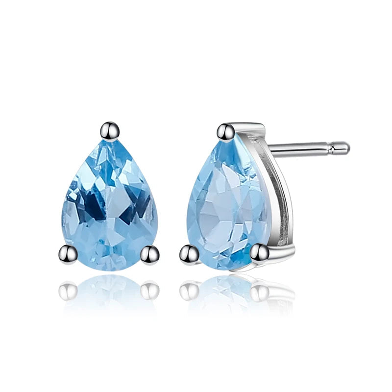 Sterling silver stud earrings with pear-shaped blue topaz gemstones in a three-prong setting