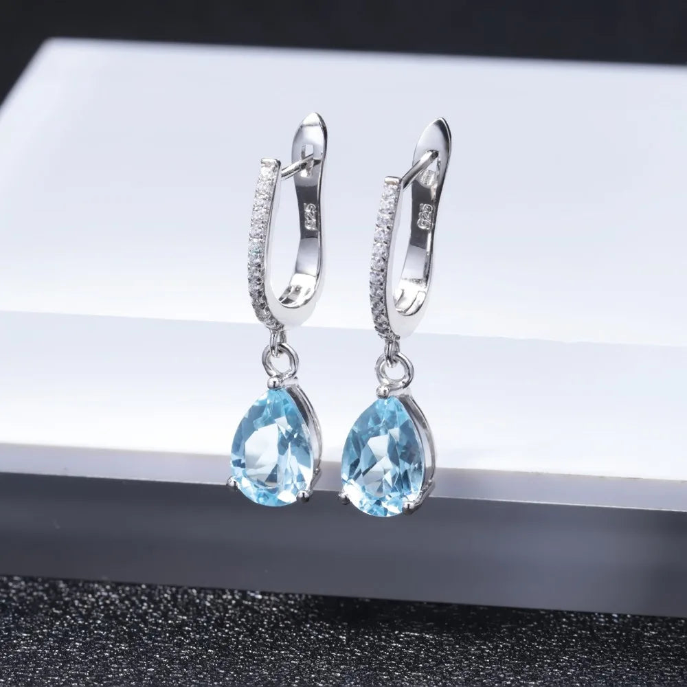 Set of three sterling silver drop earrings with pear-shaped stones in blue, navy, and violet, accented with pavé-set crystals