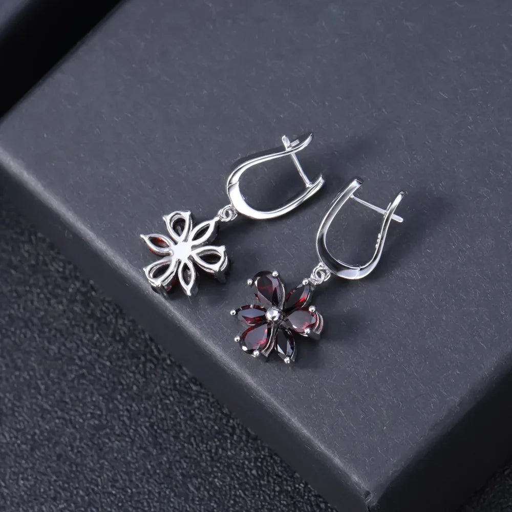 Silver floral drop earrings featuring five deep garnet-brown marquise stones arranged as petals, from the Rossa Collection.