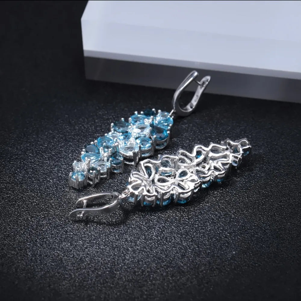Silver drop earrings with clusters of marquise and pear-cut blue gemstones in varying shades