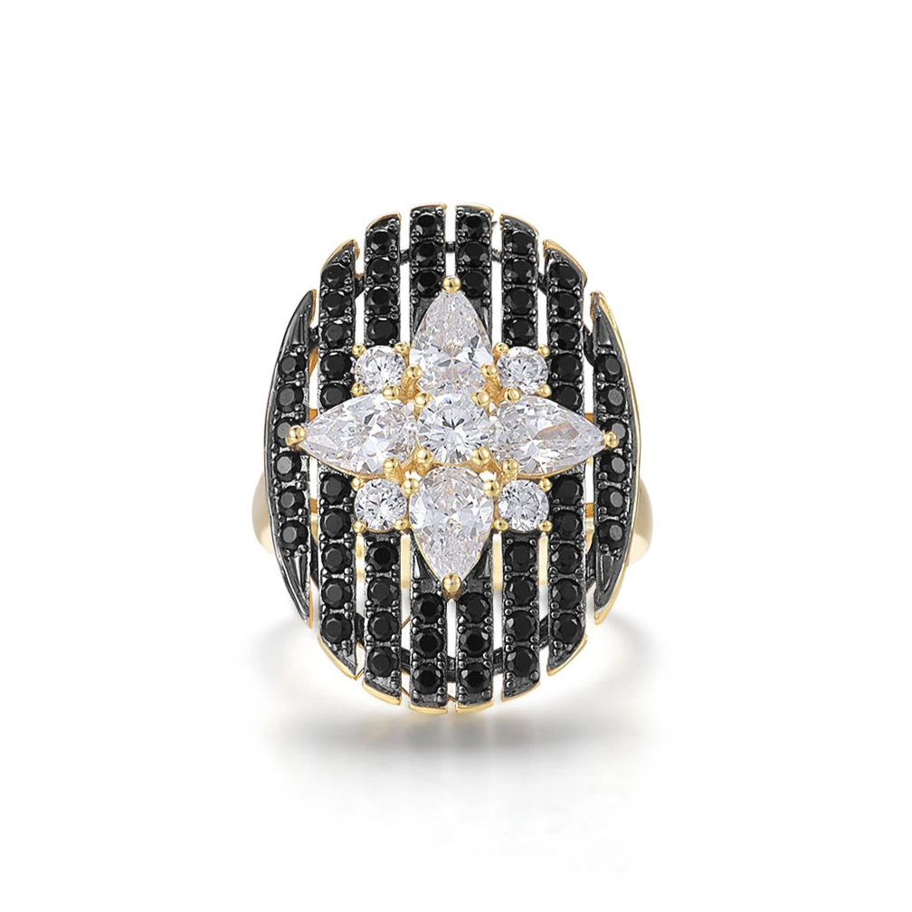 Gold ring with an oval black and white starburst design featuring clear marquise and round stones