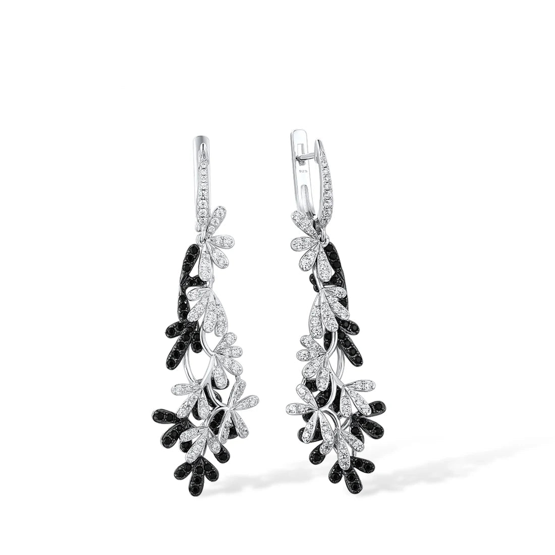 Long silver earrings with interwoven black and white gemstone-studded olive leaf designs.