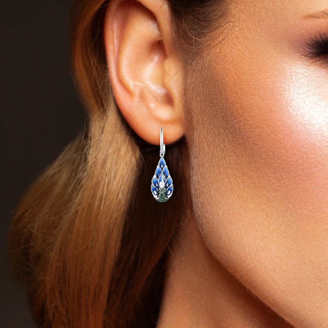 Sterling silver peacock drop earrings with blue enamel feathers and green pavé stones