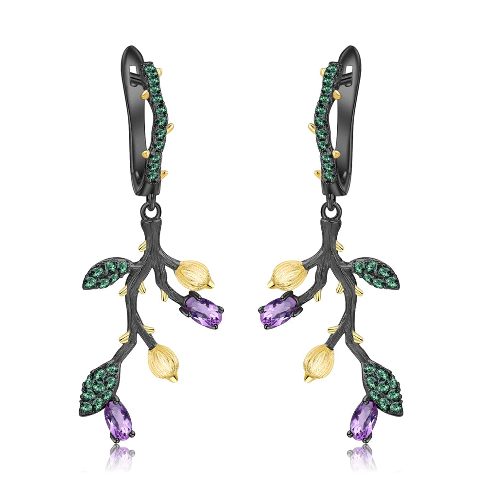 Botanical-inspired earrings with purple, green, and gold accents