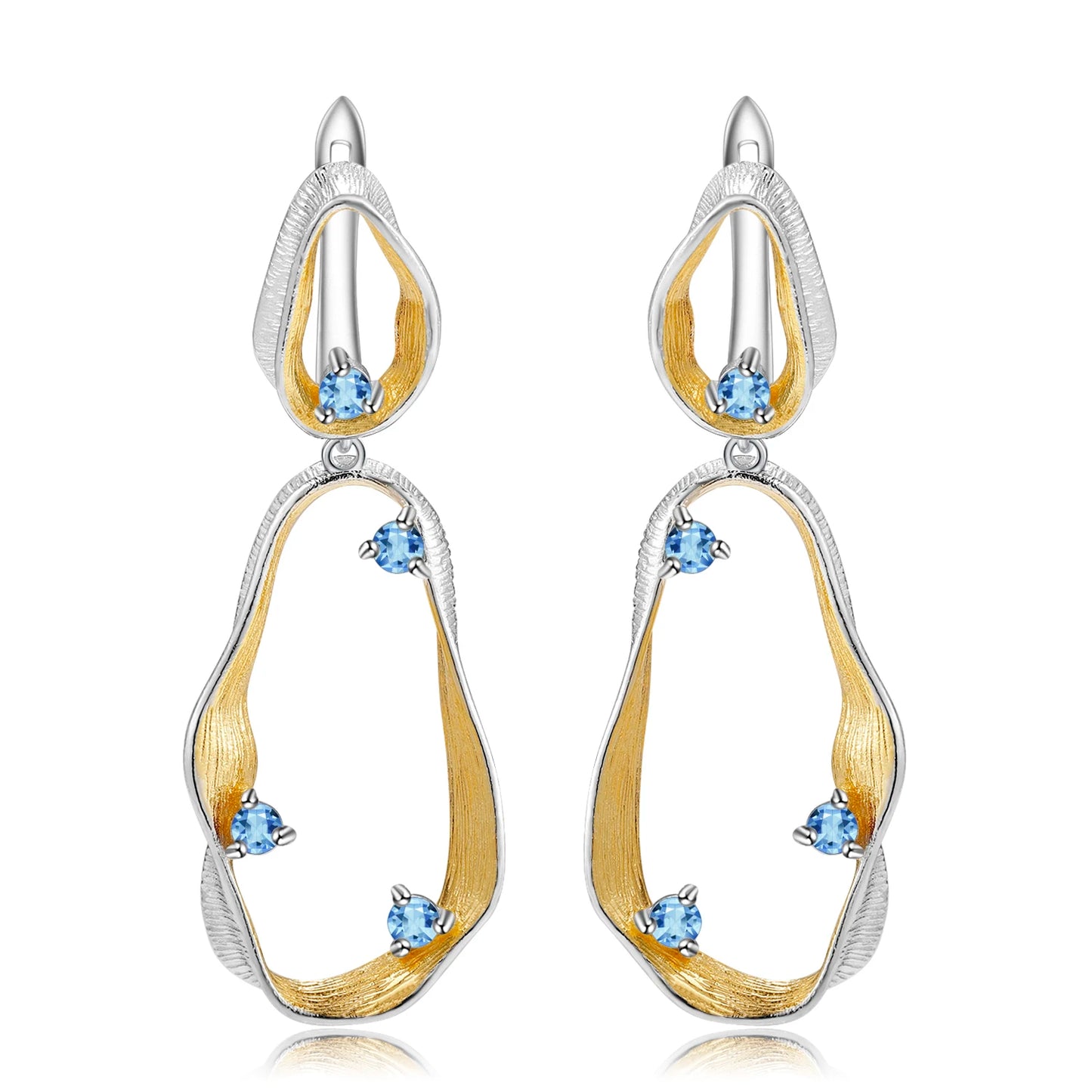 Dangling earrings with flowing gold and silver forms set with turquoise-colored stones