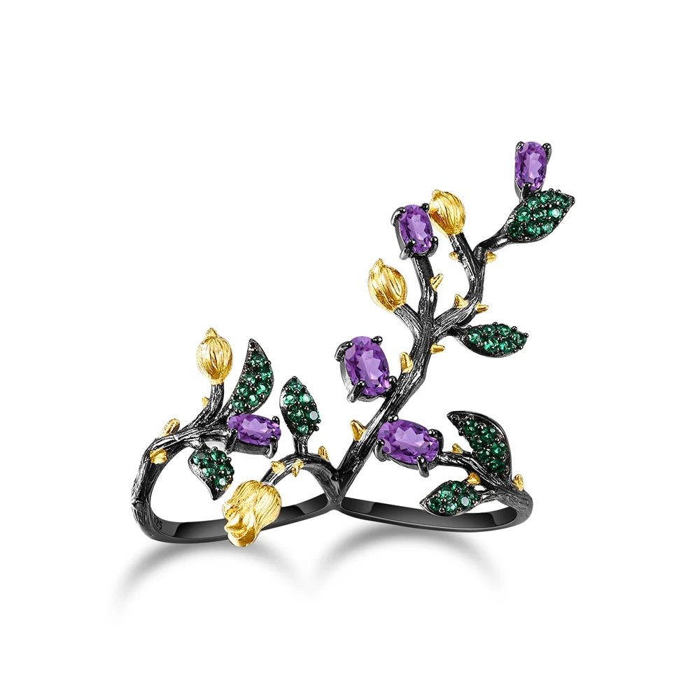 Double-finger black ring shaped like a flowering branch with purple, green, and gold detailing