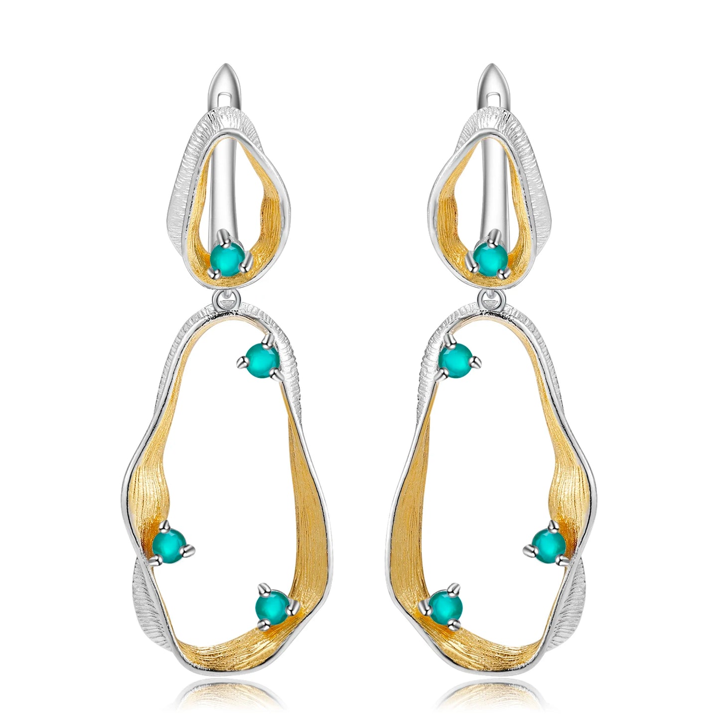 Dangling earrings with flowing gold and silver forms set with turquoise-colored stones