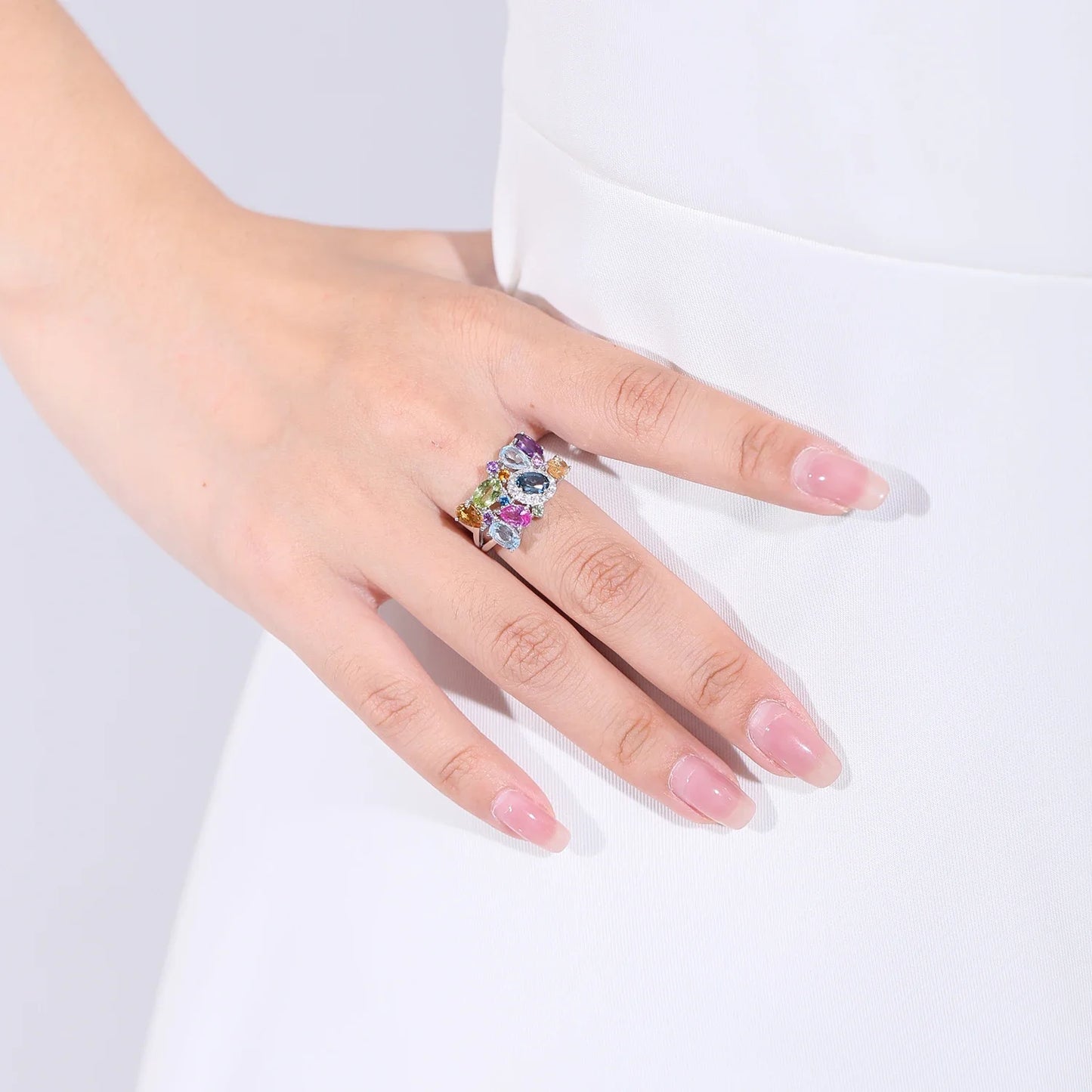 Silver ring with a cluster of multicoloured gemstones in various cuts