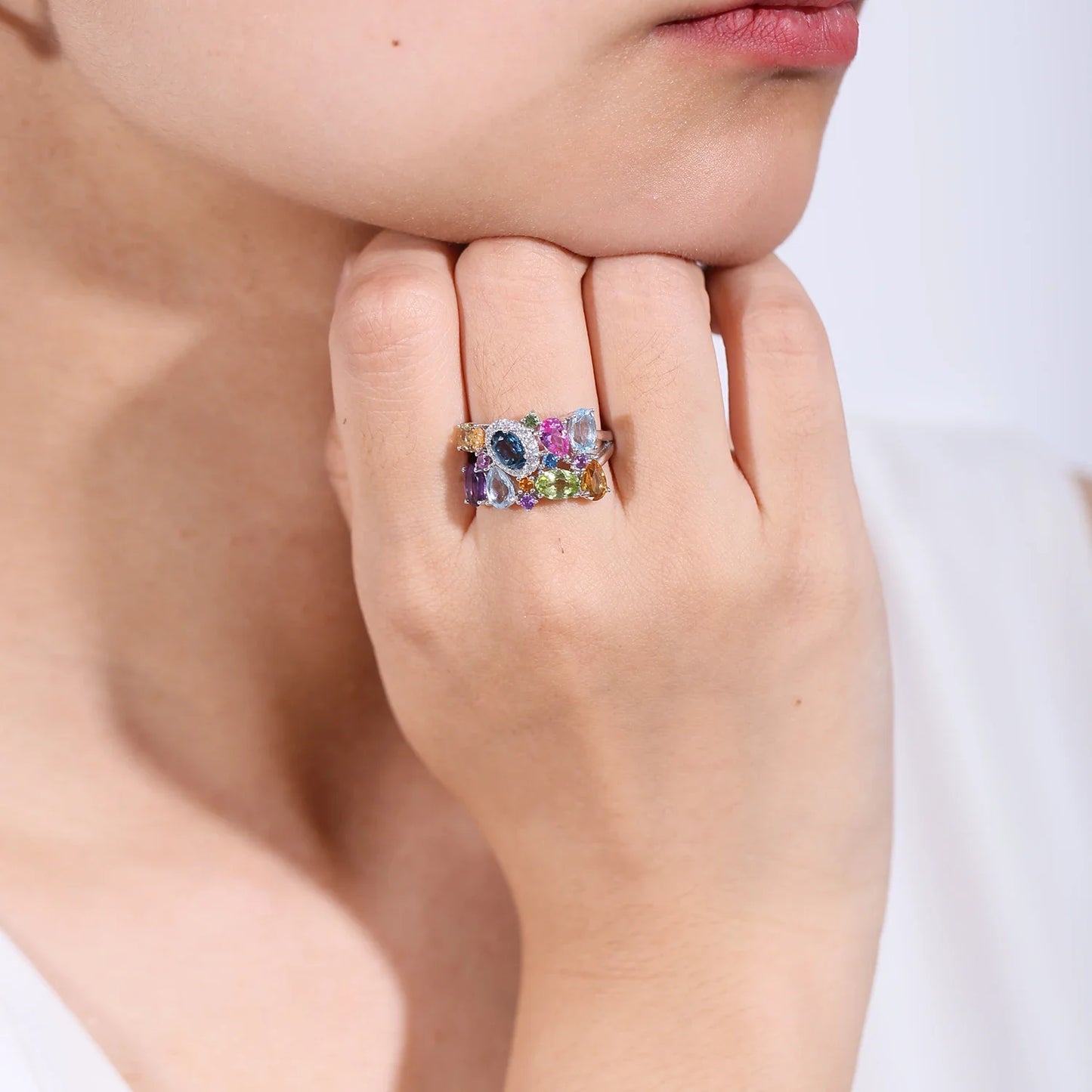 Silver ring with a cluster of multicoloured gemstones in various cuts