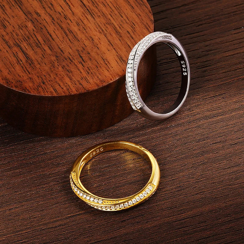 Slim silver ring featuring two parallel rows of small white stones, forming a subtle twist in the center, from the Bianco Nero collection.