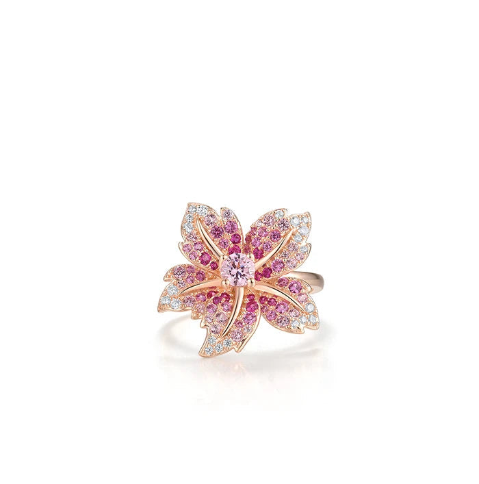 Rose gold floral ring with layered petals embellished in pink and white stones.