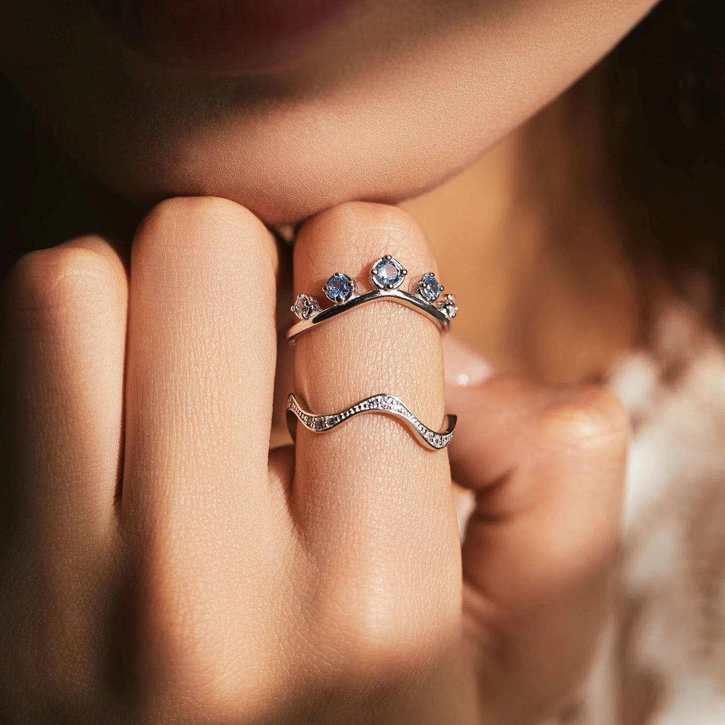 Sterling silver ring with six graduated light blue and lavender stones set in a tiara-like arc