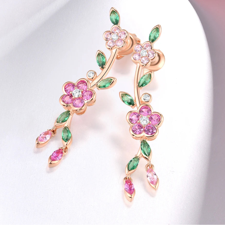 Fiore di Vite earrings with pink flower-shaped stones, green marquise-cut leaves, and delicate drop accents.