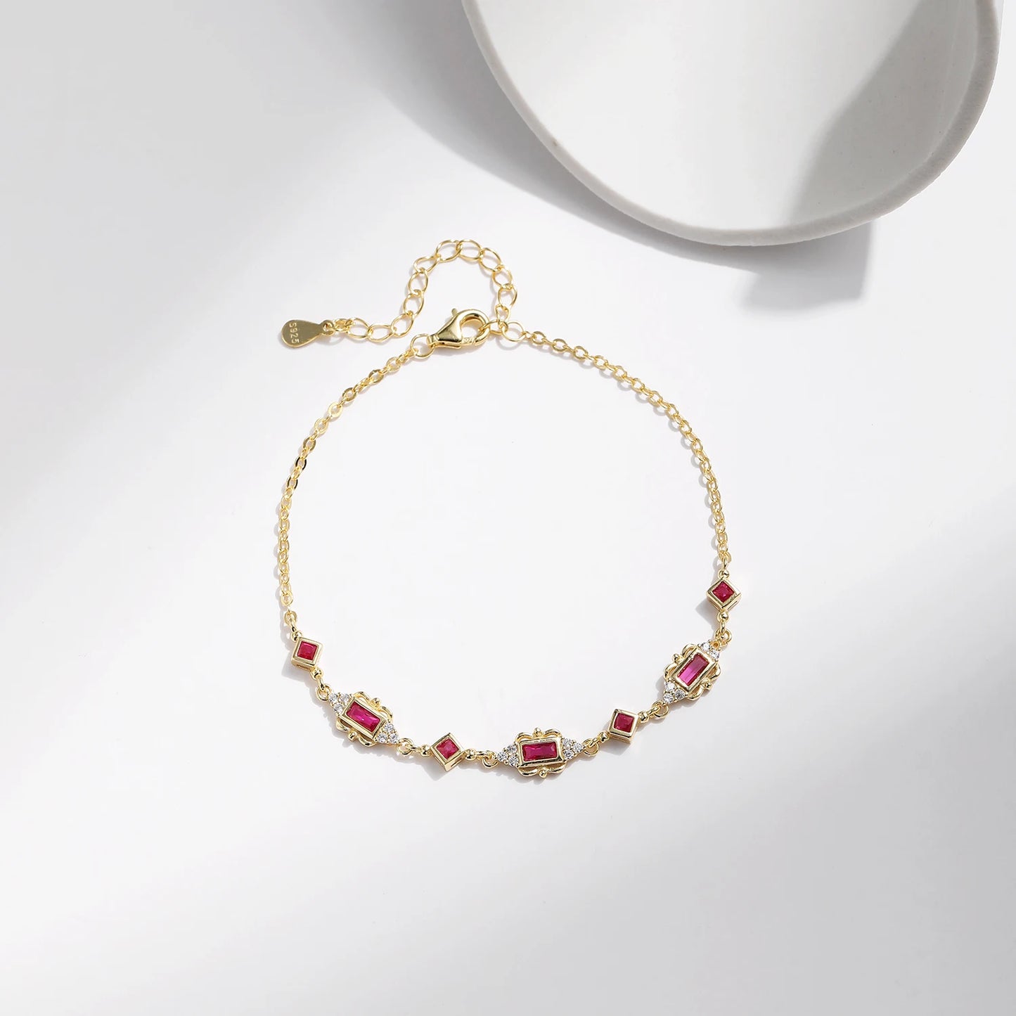 Gold-plated bracelet with ruby-red rectangular and diamond-shaped stones