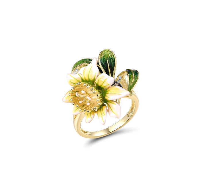 Gold floral jewelry set with white and green enamel petals, gold detailing, and brown teardrop stones
