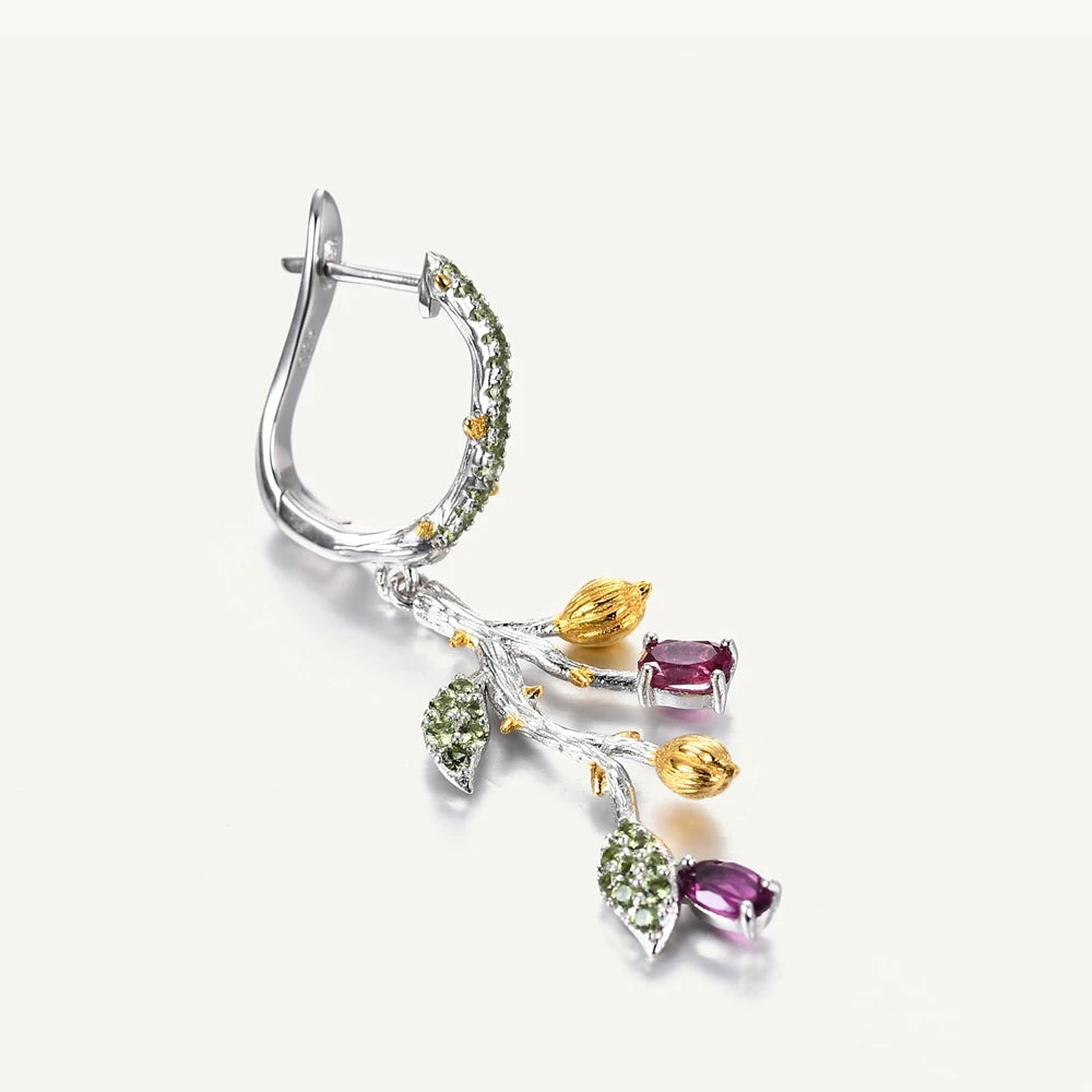 Botanical-inspired earrings with purple, green, and gold accents