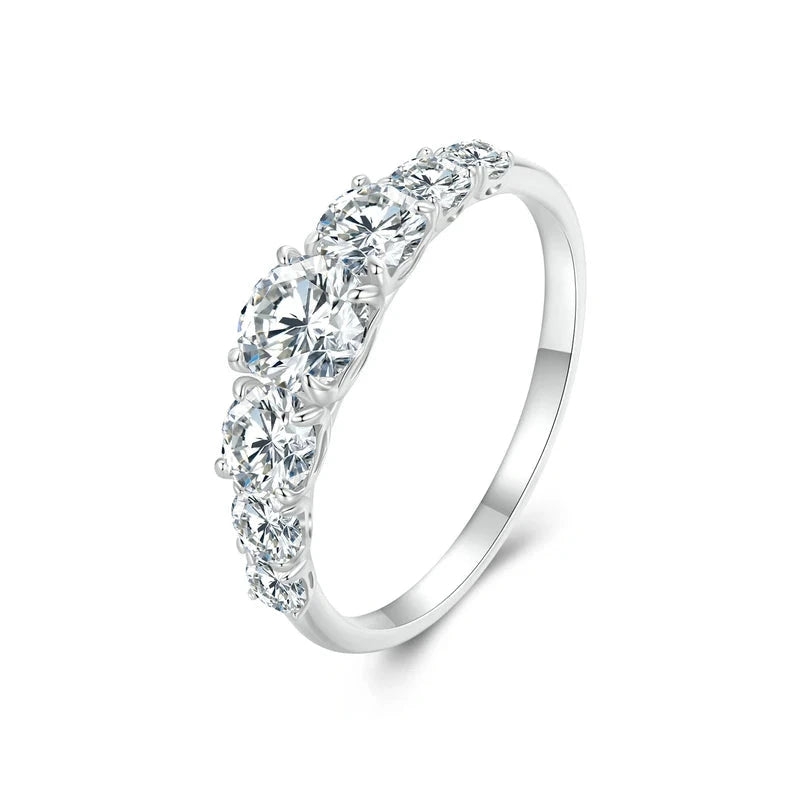 Silver band ring adorned with a sequence of round brilliant-cut stones, creating a continuous sparkling design.