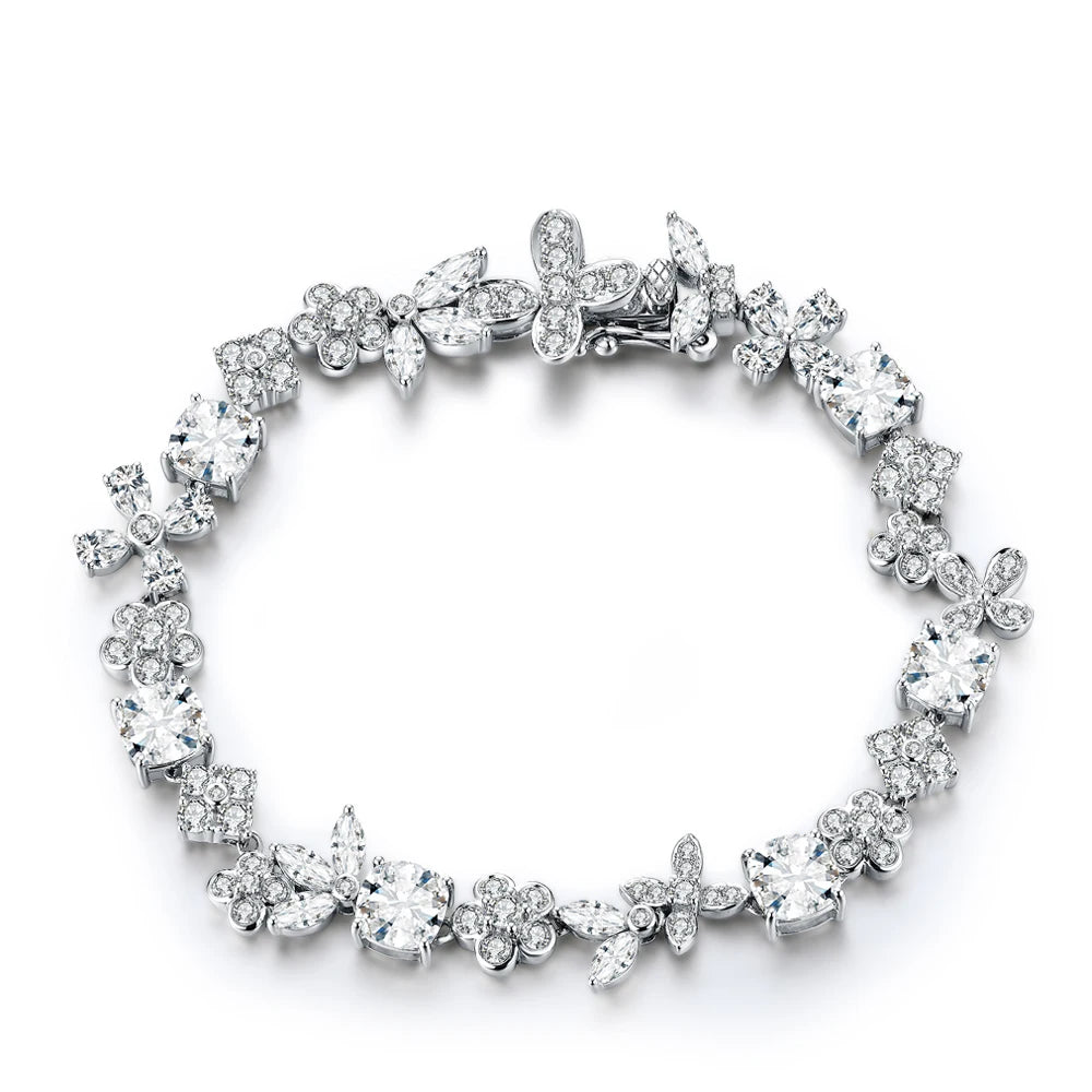 Silver bracelet adorned with alternating floral and butterfly-shaped elements, each set with sparkling white stones.