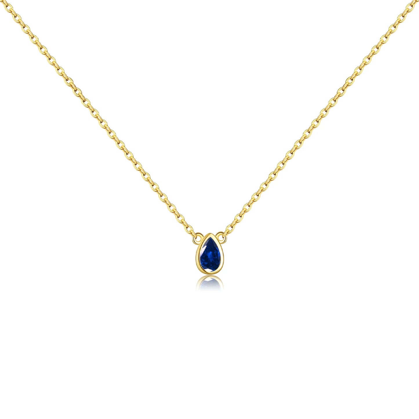 Gold chain necklace featuring a pear-shaped deep blue gemstone in a bezel setting