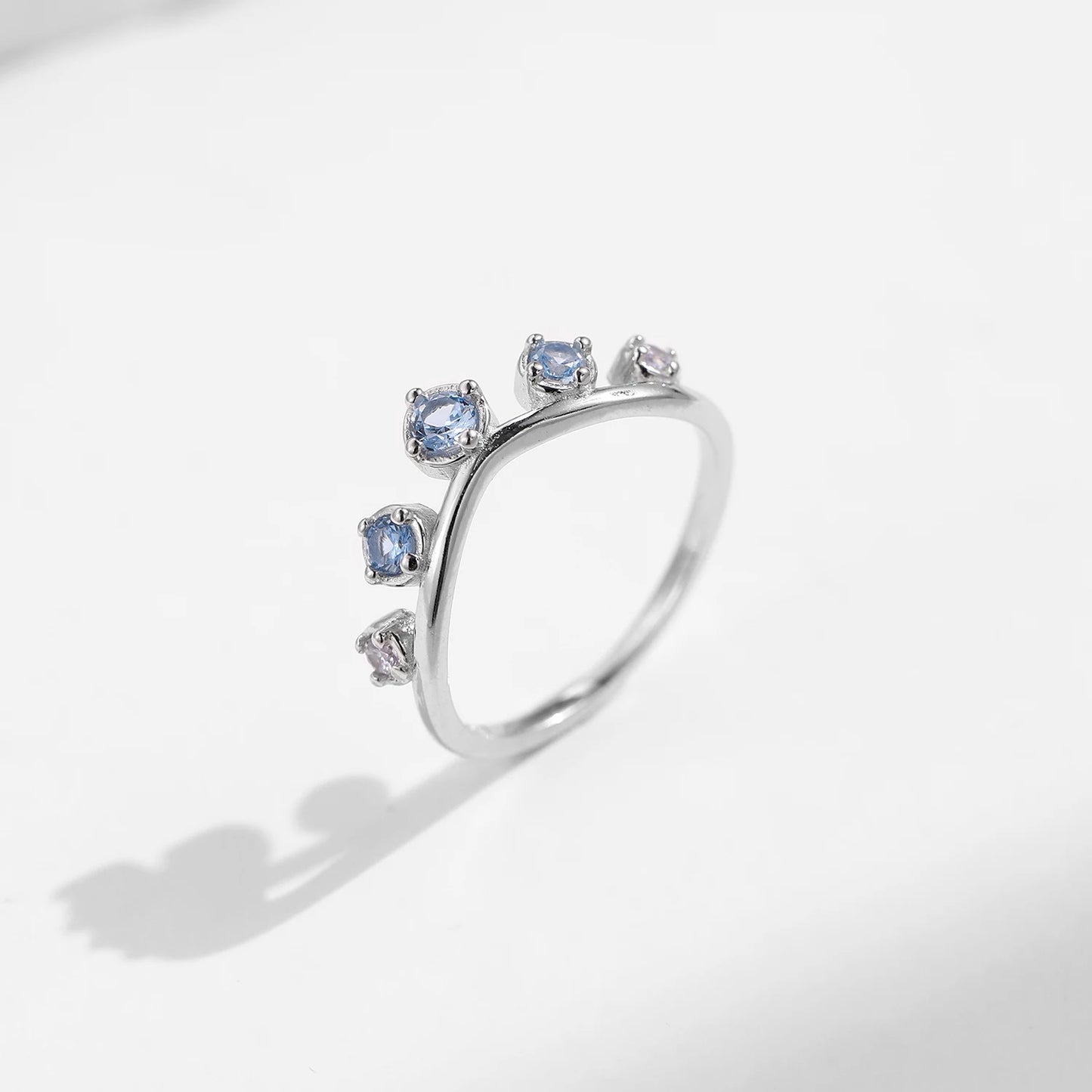 Sterling silver ring with six graduated light blue and lavender stones set in a tiara-like arc
