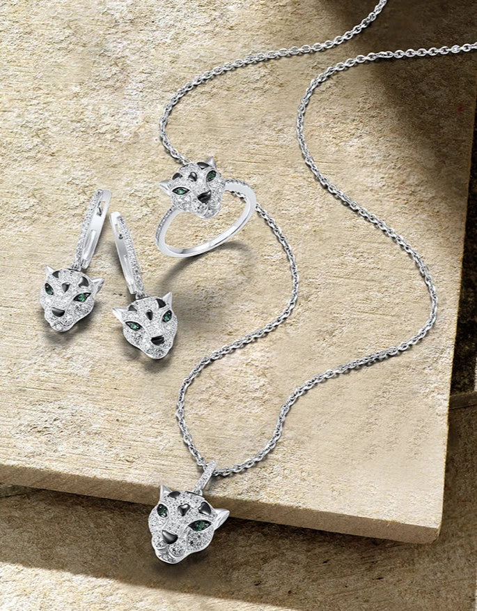 Jewelry set featuring panther head designs with pavé detailing and green gemstone eyes