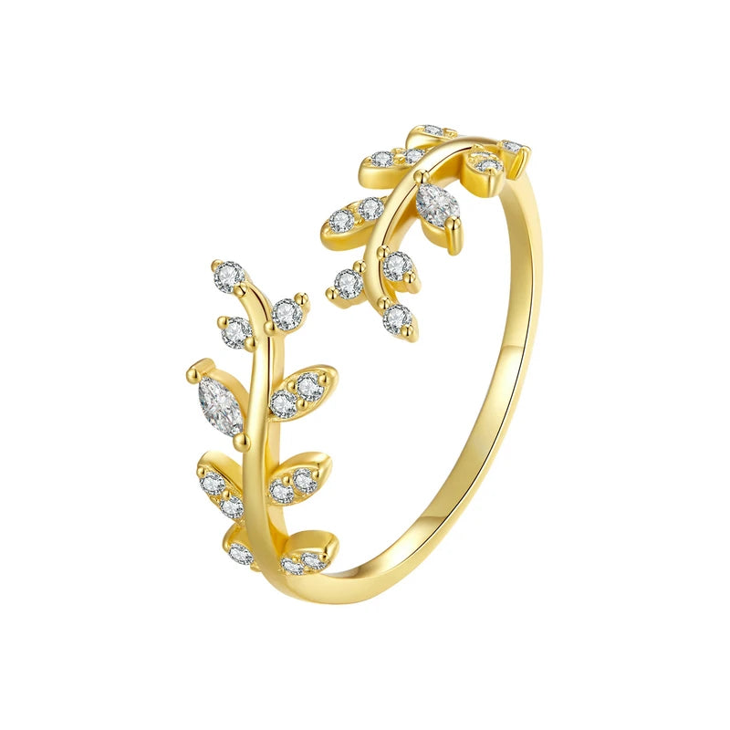 Gold-plated ring featuring two leafy branches set with clear stones, delicately curving toward each other in an open design, from the Bianco Nero collection.