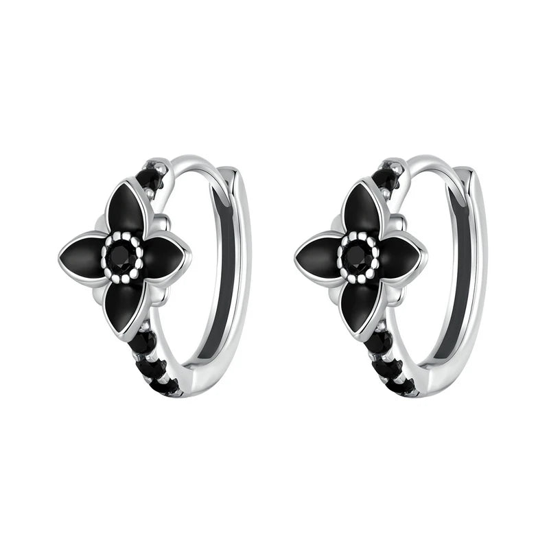 Pair of silver hoop earrings featuring black enamel flowers and black stones, from the Bianco Nero collection.