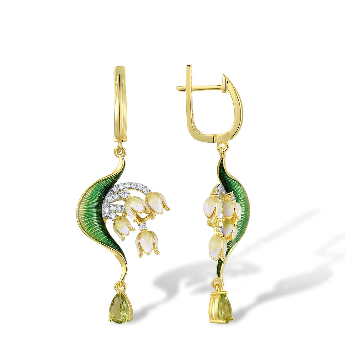 Close-up of a nature-inspired jewelry set featuring a green enameled leaf design with white and yellow floral elements, accented with sparkling stones and gold detailing.