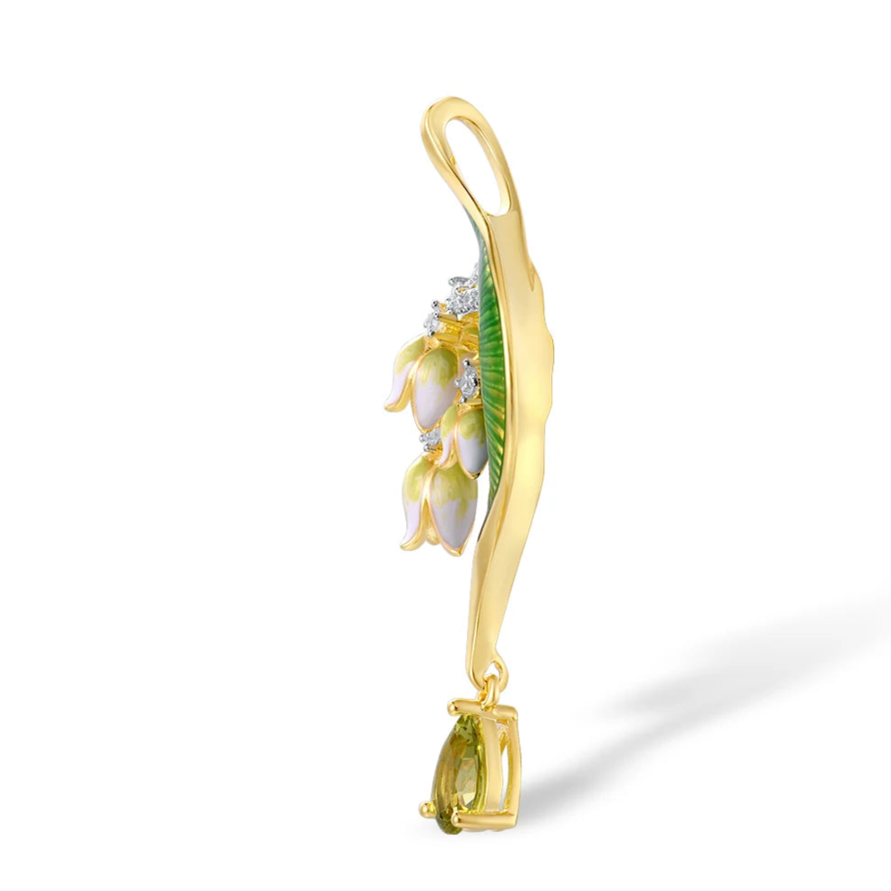 Gold brooch with green enamel leaf, white and pink floral drops, and teardrop green gemstone