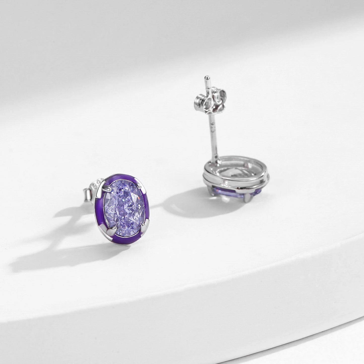 Set of three sterling silver stud earrings with deep blue, aqua, and lavender stones framed in coloured enamel
