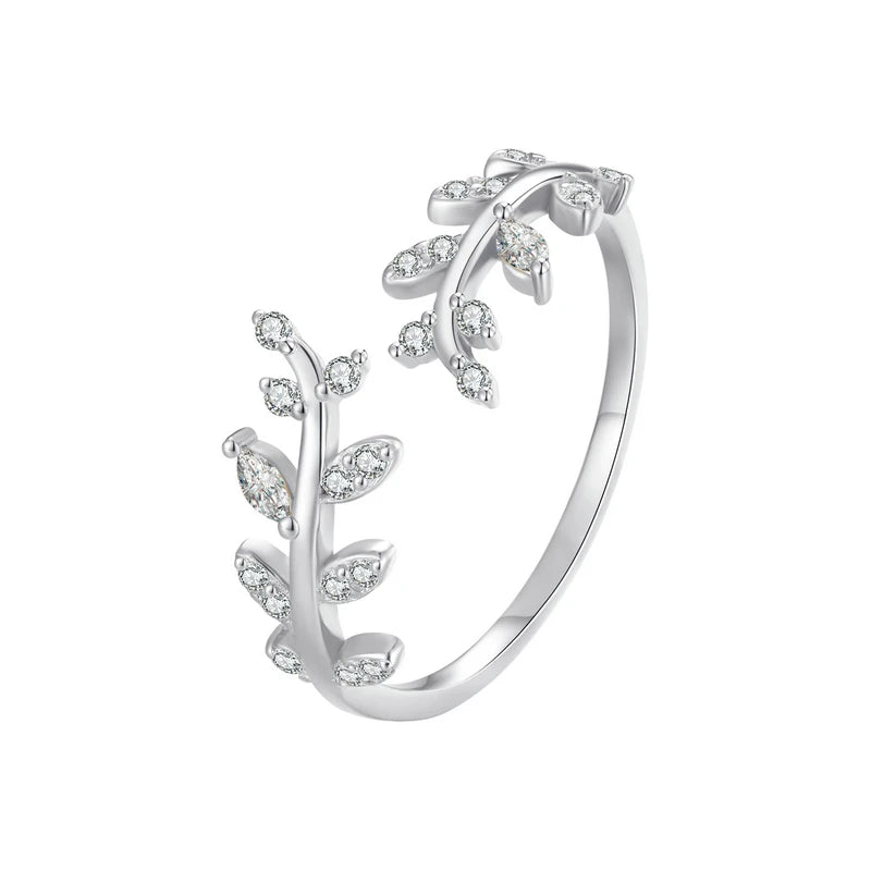 Gold-plated ring featuring two leafy branches set with clear stones, delicately curving toward each other in an open design, from the Bianco Nero collection.