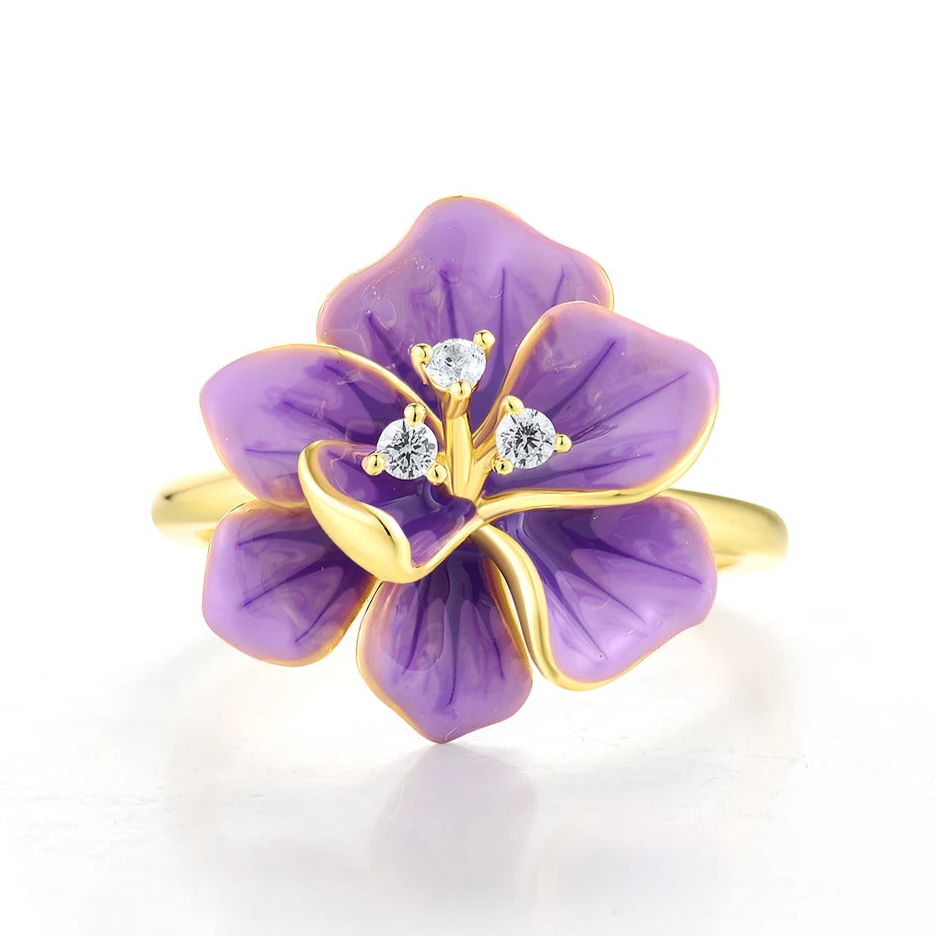 Gold ring with purple enamel flower and sparkling white stones