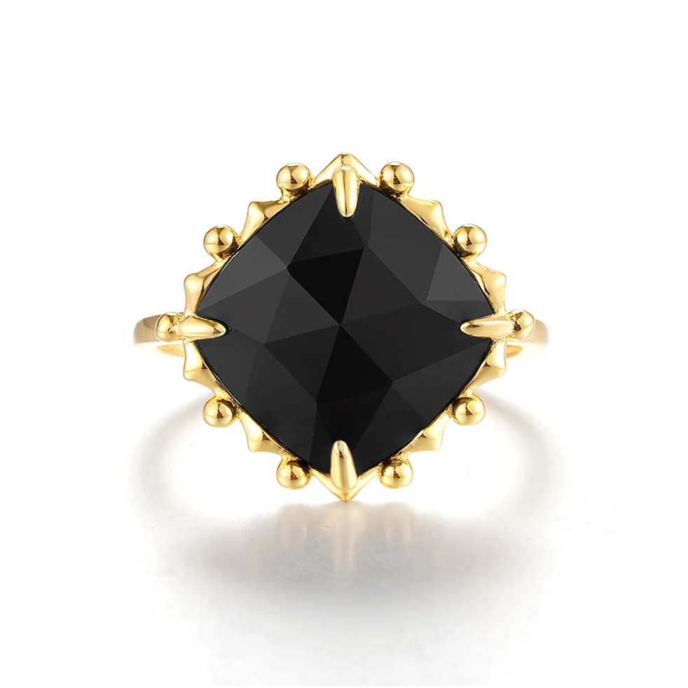 Gold ring with a large cushion-cut black stone and decorative claw prongs.