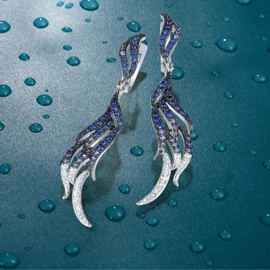 Sterling silver drop earrings with blue and white crystal feather design