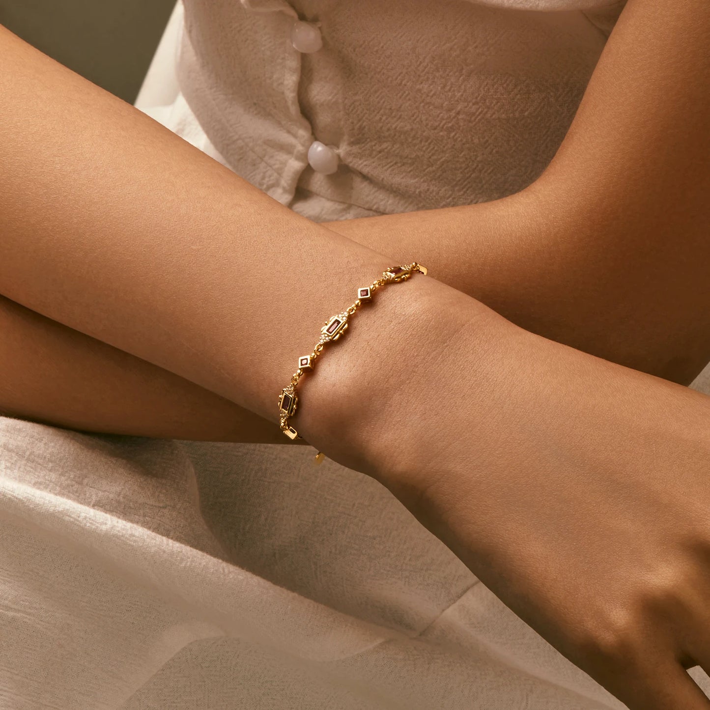 Gold-plated bracelet with ruby-red rectangular and diamond-shaped stones