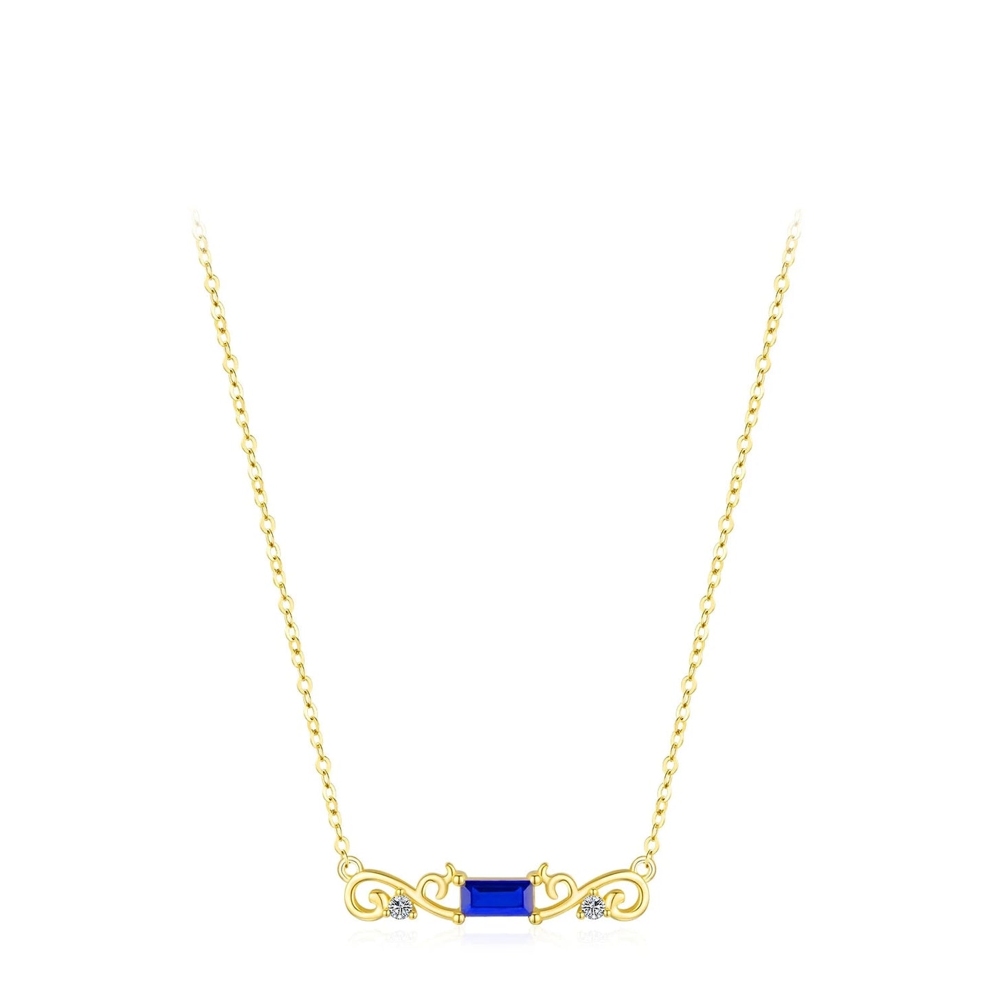 Gold necklace with a central rectangular deep blue gemstone flanked by scroll-like gold accents and small clear crystals