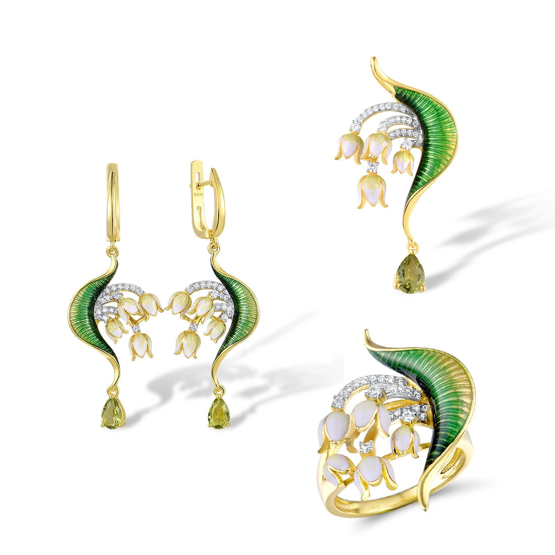Close-up of a nature-inspired jewelry set featuring a green enameled leaf design with white and yellow floral elements, accented with sparkling stones and gold detailing.
