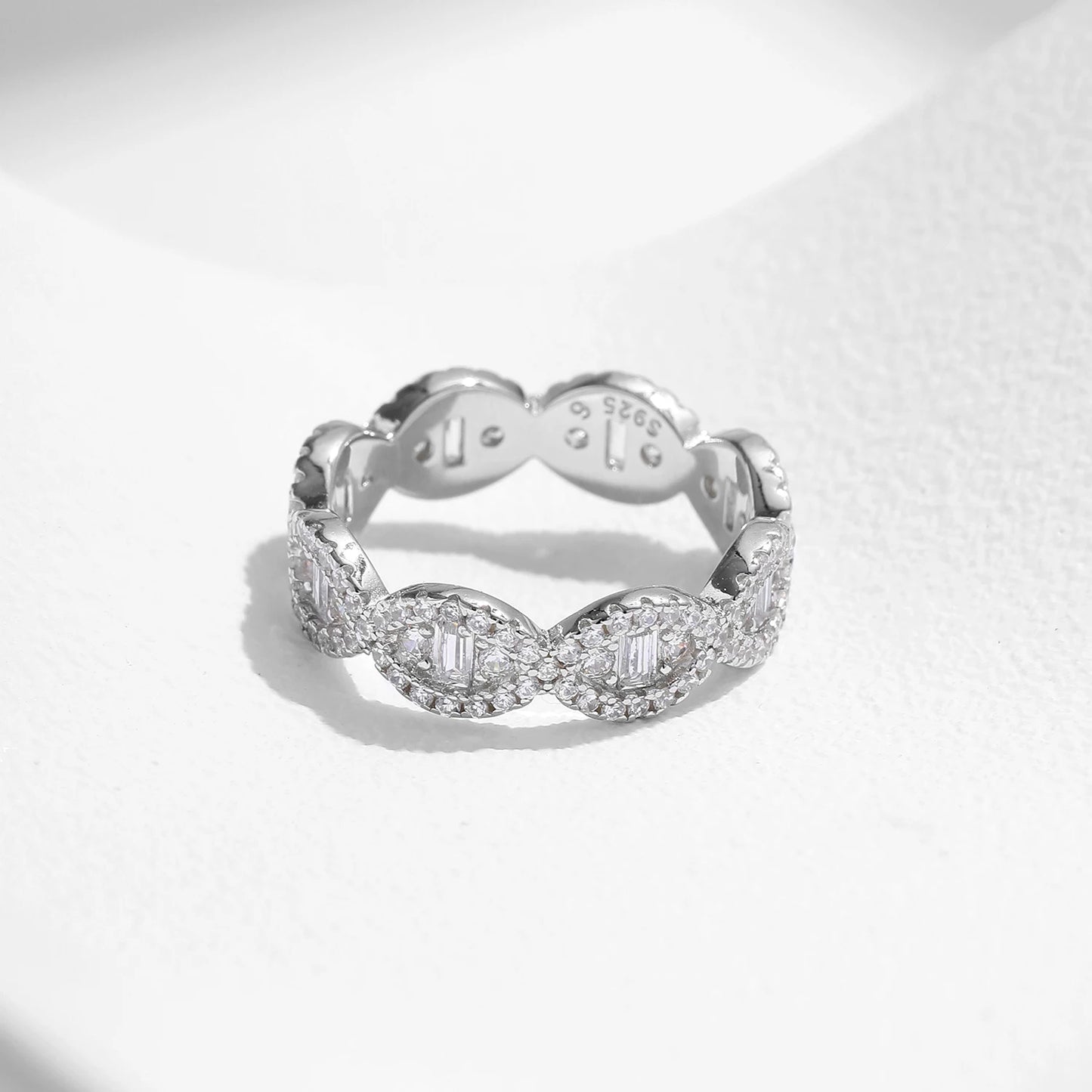 Silver eternity band with scalloped edges and baguette-cut cubic zirconia accents