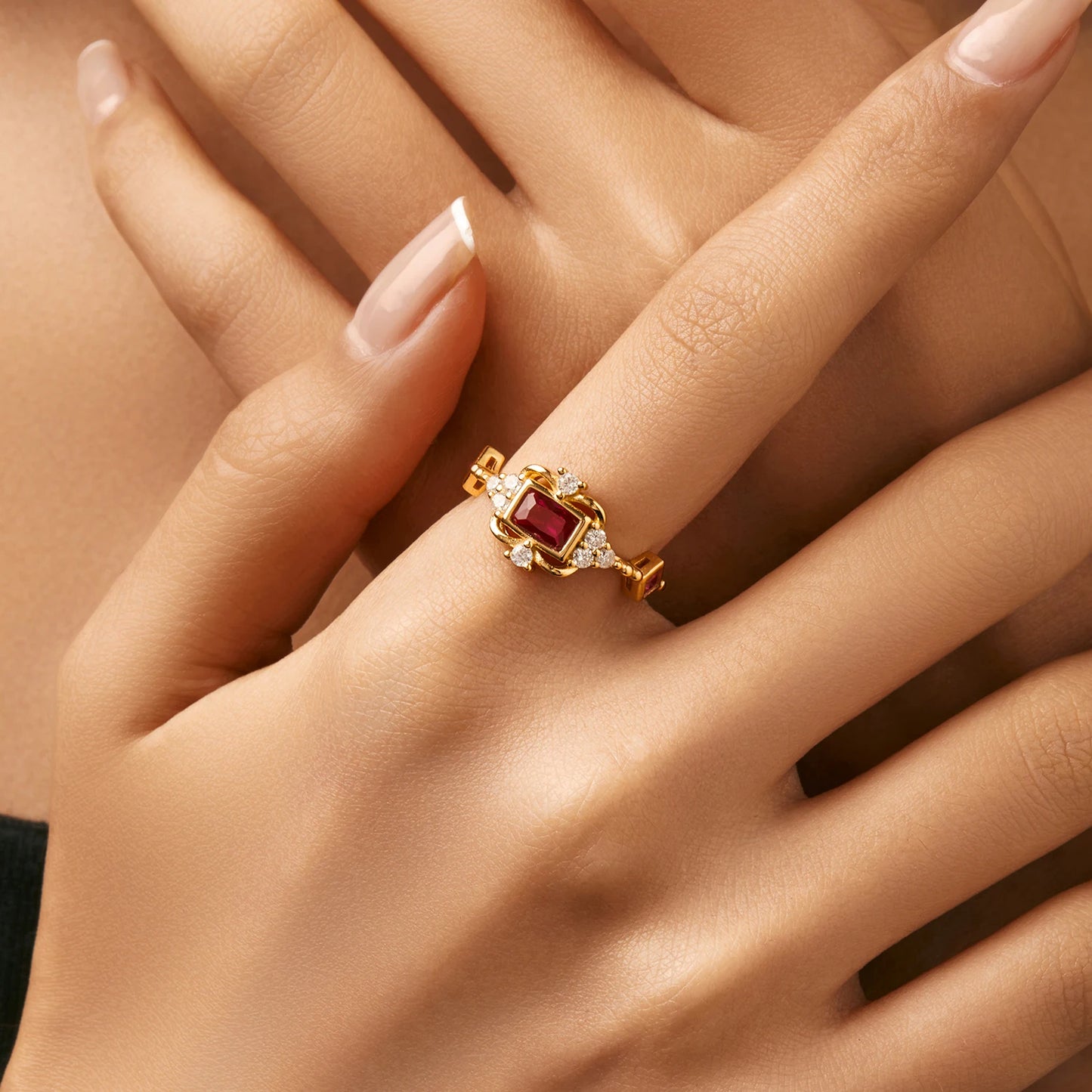 Gold-plated ring with rectangular ruby-red stone and vintage-inspired clear accents