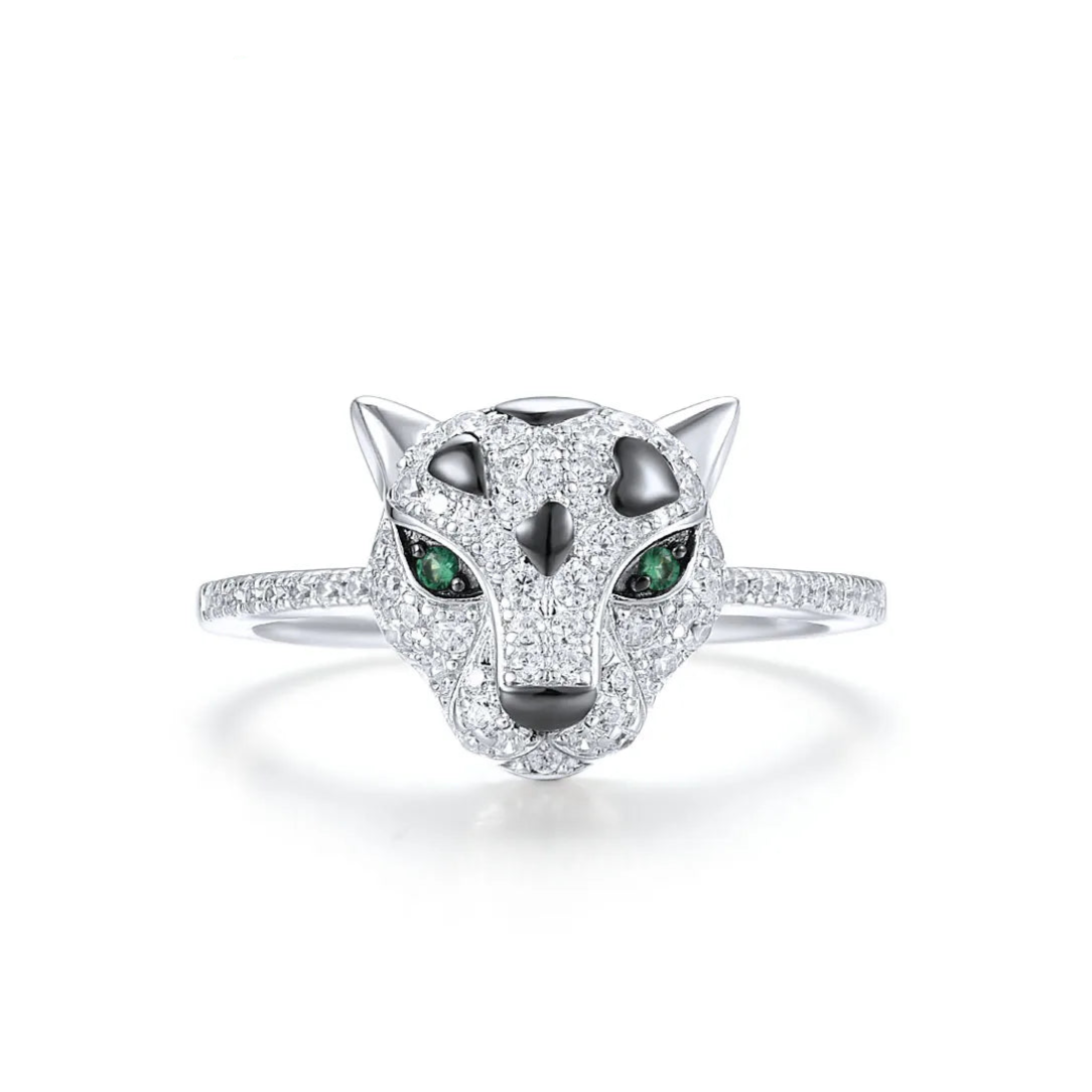 Panther head ring with pavé detailing and green gemstone eyes
