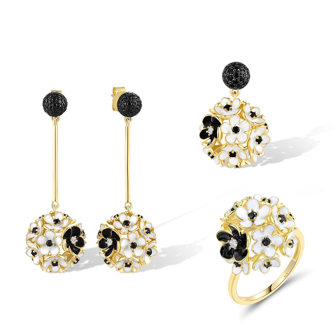 Fiore Scuro jewelry set featuring gold-tone earrings, ring, and pendant with white and black floral detailing from the Bianco Nero collection.
