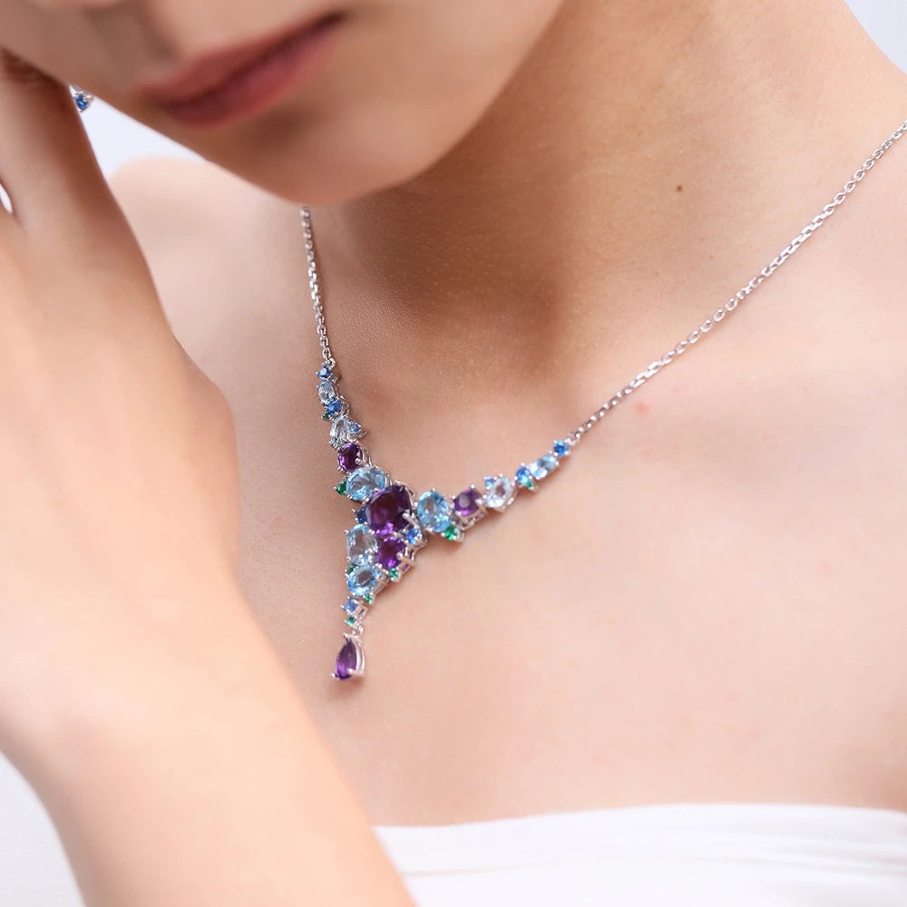 Necklace with gradient blue and green gemstones arranged in an organic cascading pattern