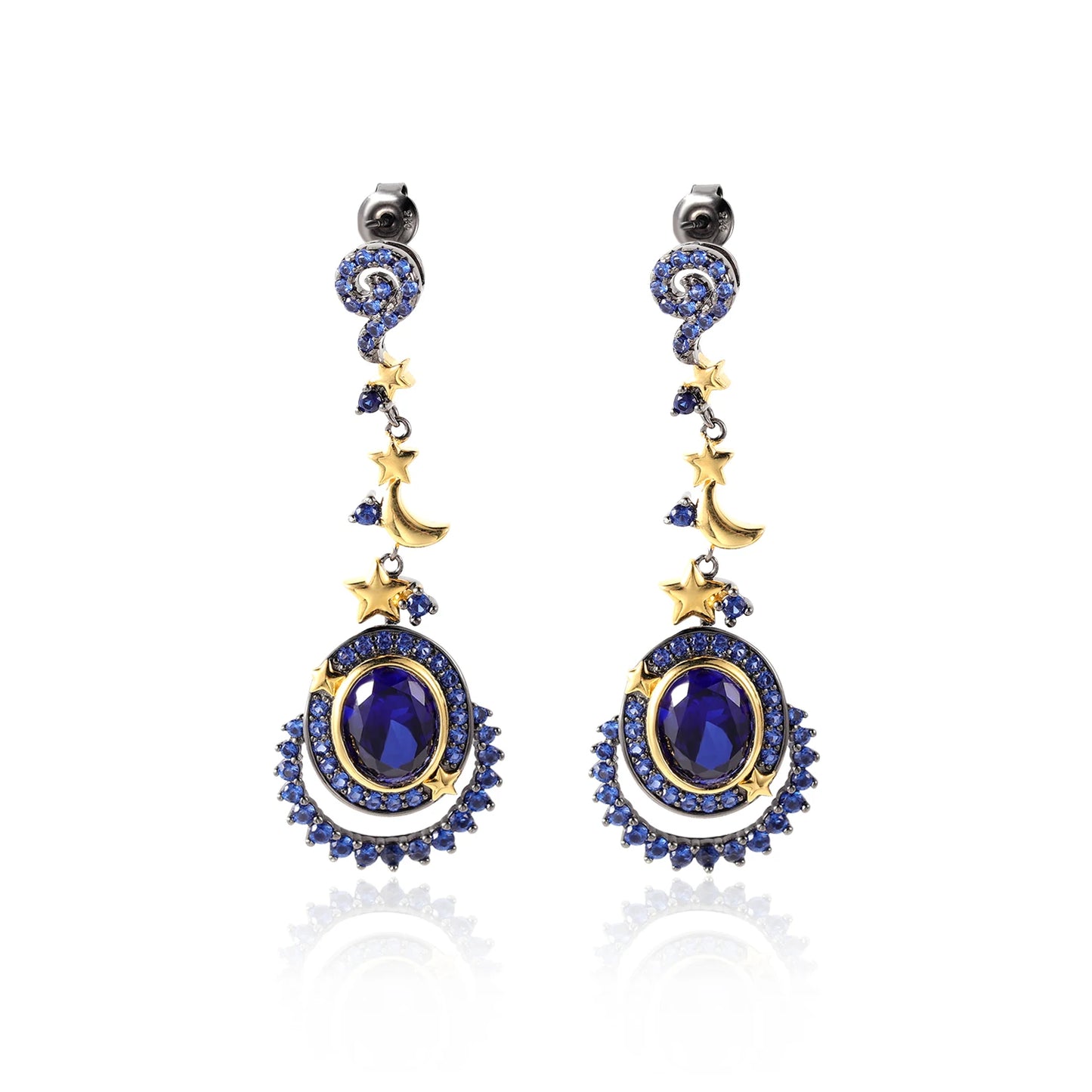 Dangling earrings with gold moon and star charms, deep blue oval stones, and pavé-set blue crystals in a celestial design