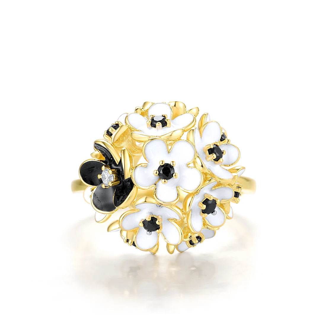 Gold ring featuring a cluster of white and black enamel flowers with dark gemstone centers.