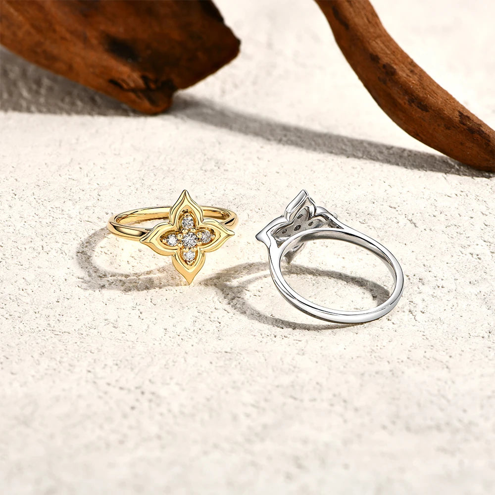 Gold and silver rings on a sandy surface with wooden elements.